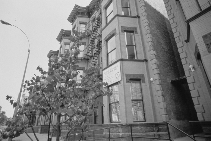 FIGS. 3, 4: Bedford-Stuyvesant Restoration Corporation has created or preserved more than 2,200 units of housing and restored the facades of more than 150 homes. Pictured here are “before” and “after” views of one of the corporation’s housing preservation projects from the early 1980s. Images are property of Pratt Center for Community Development.