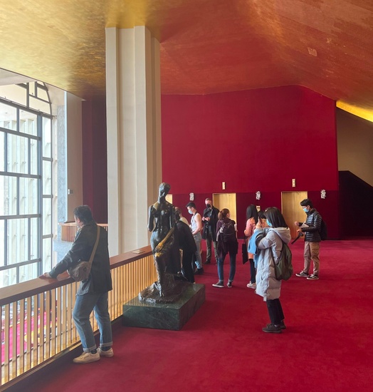 Students stand on the balcony of the Met Opera