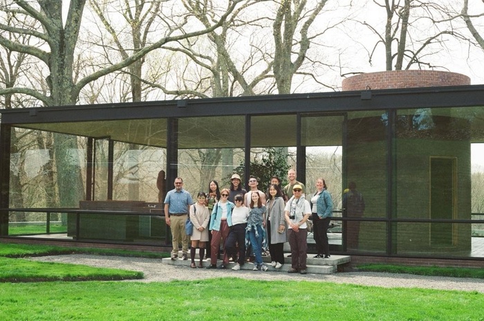 Students and faculty stand in front of Philip Johnson's Glass House