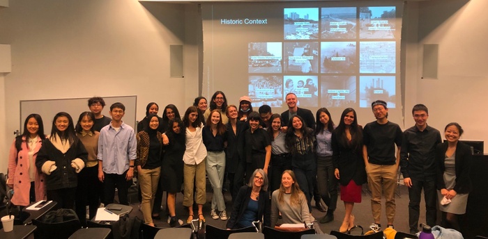 Students, Professors, and TAs stand in front of a classroom